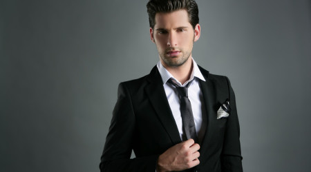 Fashion young businessman black suit casual tie